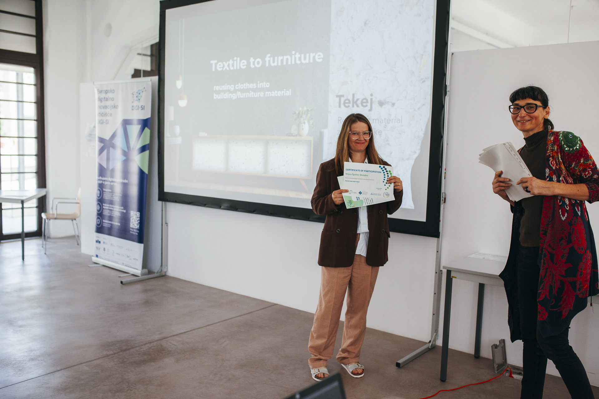 A woman is receving recognition in the form of a diploma