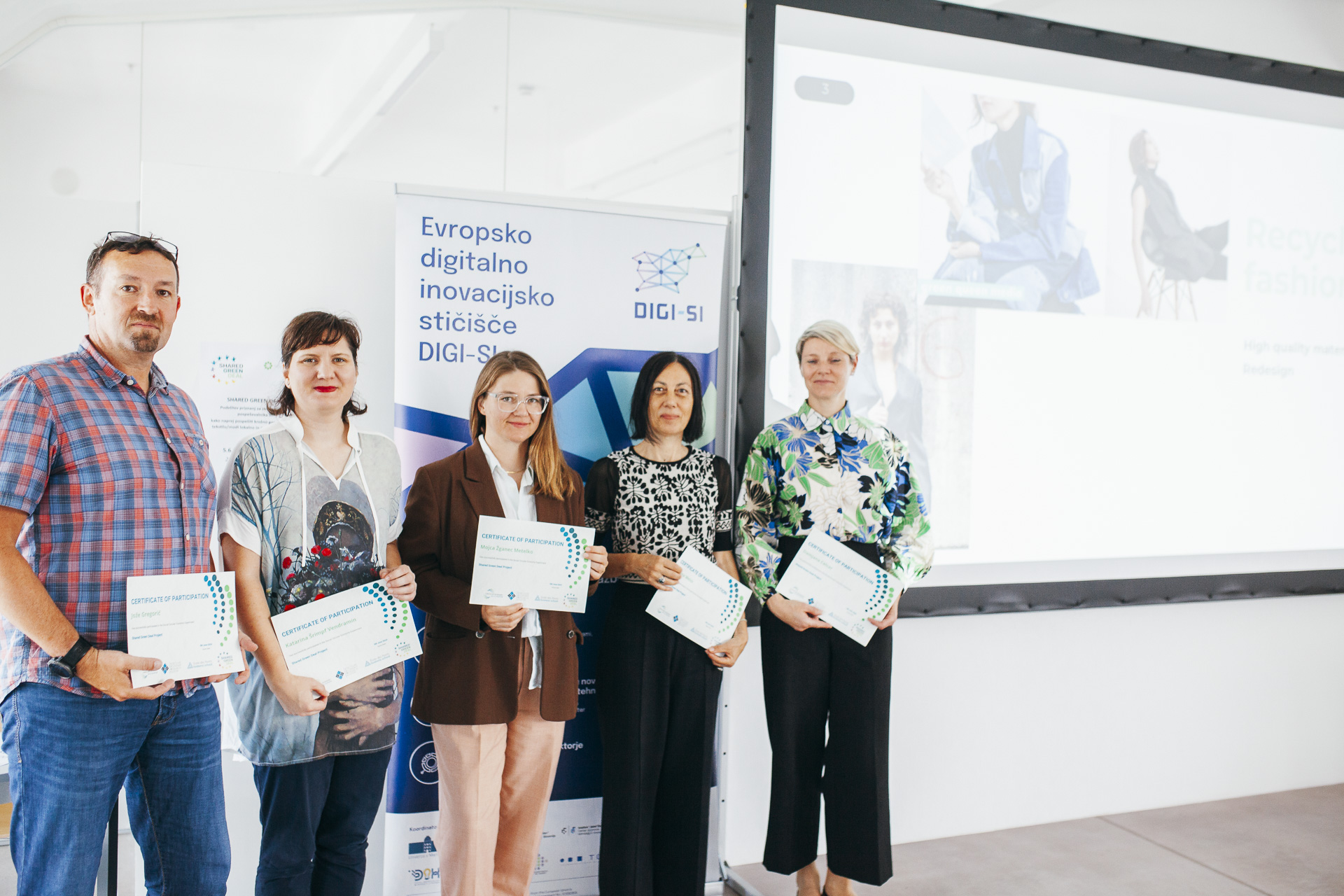 A group of people are receiving recognition in the form of a diploma