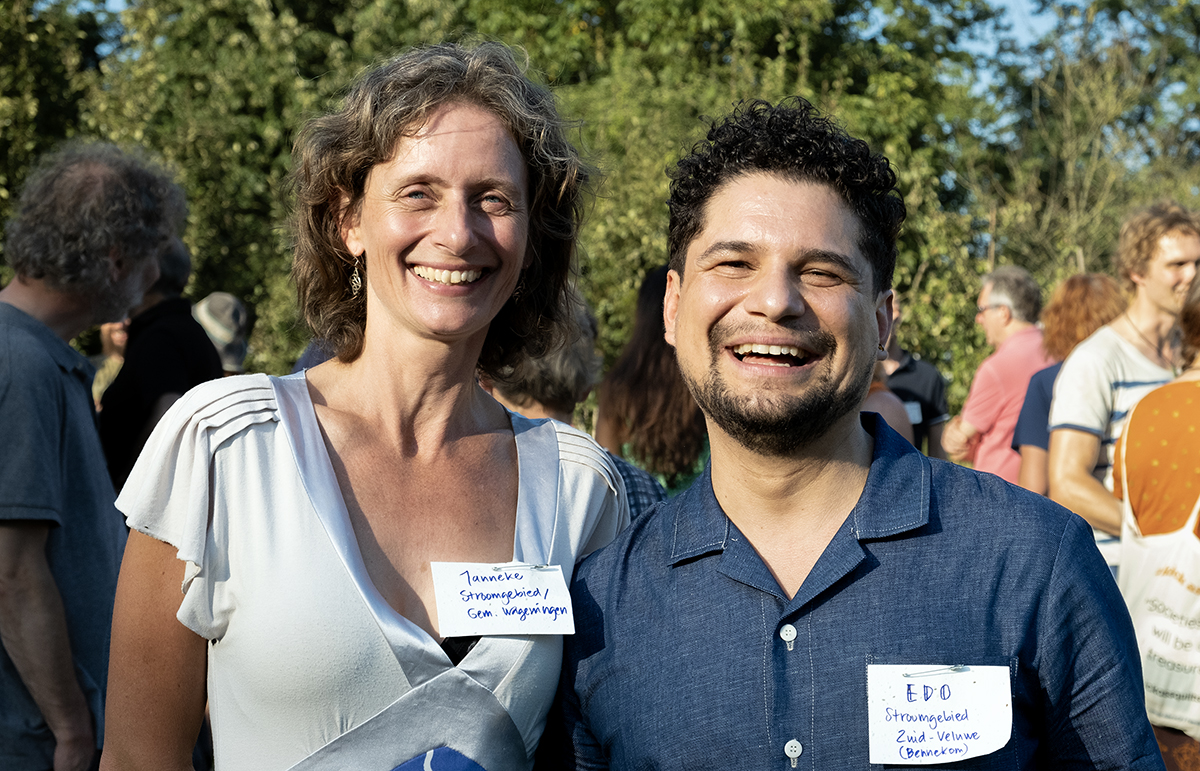 Two people smiling at the camera