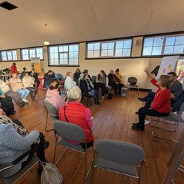 A group of people sitting around in a room.