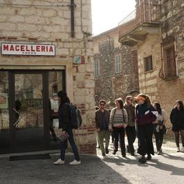 A photo of the local partners of SHARED GREEN DEAL's Food Steam walking in front of a local shop