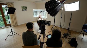 A photo of people filming an interview