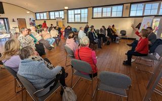 A group of people sitting around in a room.