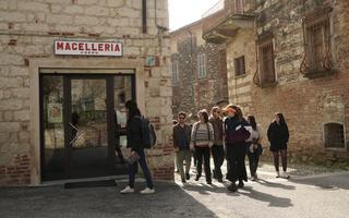 A photo of the local partners of SHARED GREEN DEAL's Food Steam walking in front of a local shop