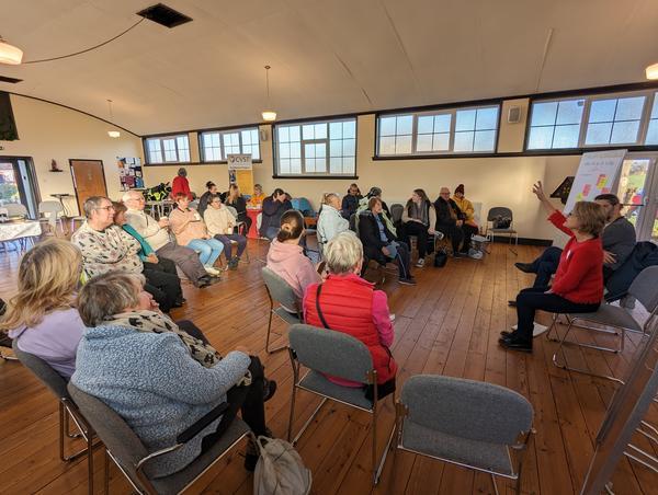A group of people sitting around in a room.