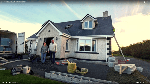 A photo of the house and two (assumed) residents