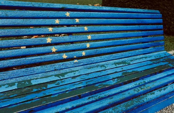 A photo of a bench, painted in European blue with stars in the miccle